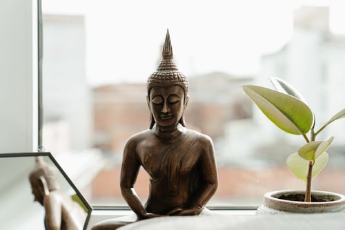 Gold Buddha Statue on Table