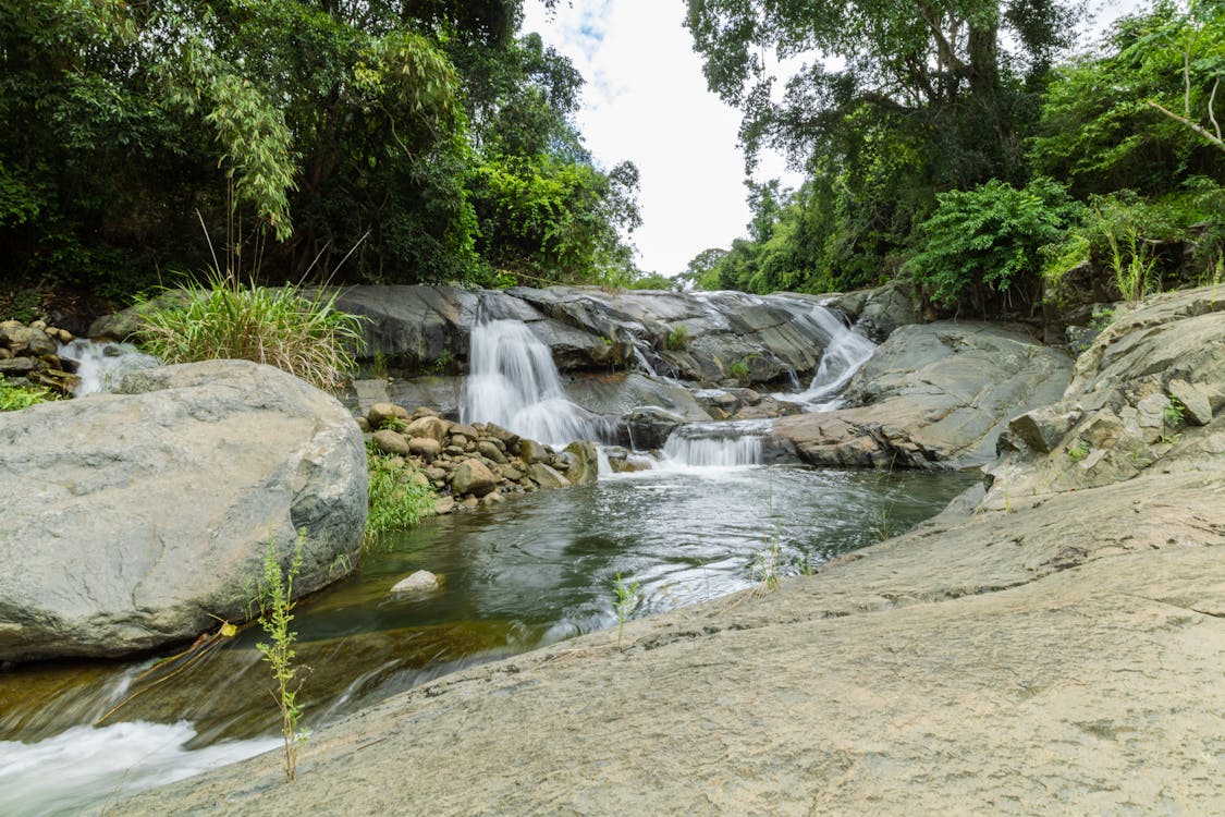 free-photo-of-a-waterfall-in-the-jungle-surrounded-by-rocks